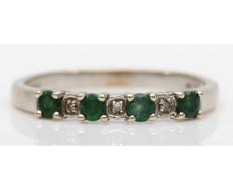 A 9ct white gold emerald and diamond dress ring, R, 1.6gm. 