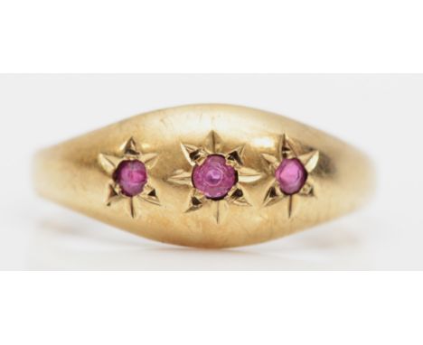 A 9ct gold three stone ruby dress ring, N, 1.7gm. 