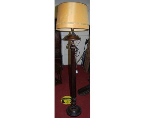 A mahogany reeded pedestal standard lamp with shade
