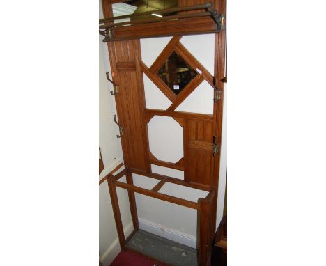 An Edwardian reeded and panelled oak mirrorback hallstand, with brass scarf rail and twin division stickstand, w.75cm