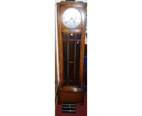 A 1930s oak longcase clock, the silvered dial signed Enfield Made in England, with glazed trunk door and triple weight driven