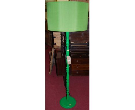 A contemporary green painted turned standard lamp, with matching colour shade