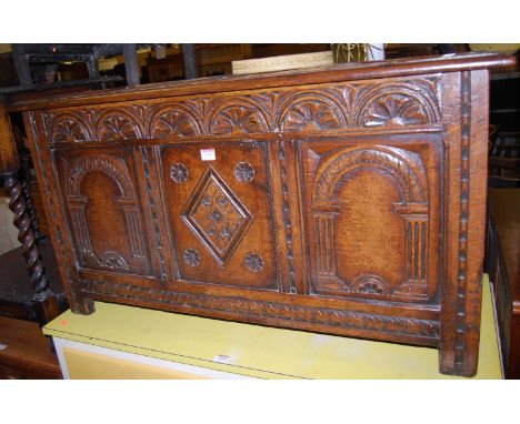 An early 20th century relief carved and joined oak three panelled hinge top coffer, width 106cmCondition report: Central pane