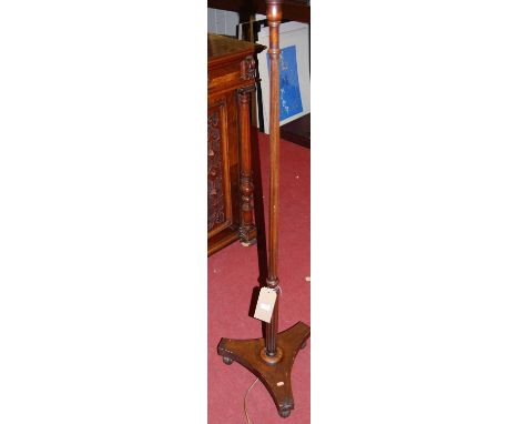 A circa 1900 mahogany fluted and reeded column standard lamp, raised on triform base