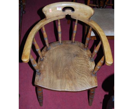 A pair of early 20th century elm and beech captains chairs, on ring turned supports