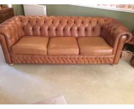 A good contemporary tan leather and brass studded three seater button back Chesterfield, width 225cm