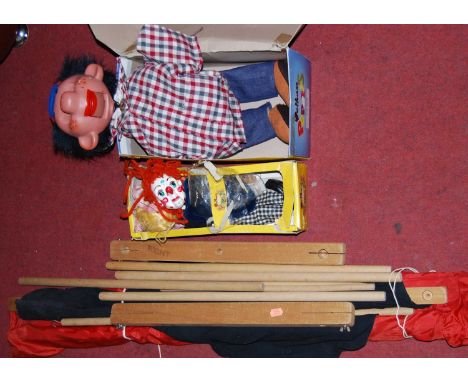 A boxed Pelham ventriloquist puppet; together with one other Pelham puppet, and a travelling puppet theatre with backdrop (3)