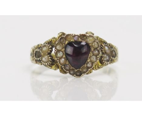 A 19th Century Heart Shaped Ring with foil backed cabochon gem and split pearls in a high carat precious yellow metal setting