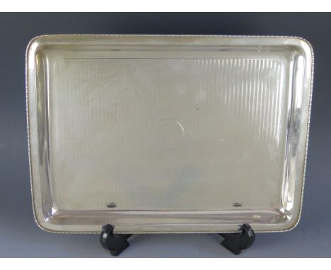 A George V silver dressing table tray, maker's mark worn and rubbed, Birmingham, 1912, of rectangular outline with beaded bor