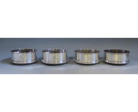 A set of four Elizabeth II silver coasters, maker M C Hersey &amp; Son Ltd, London, 1987, initialled, with turned wood bases,
