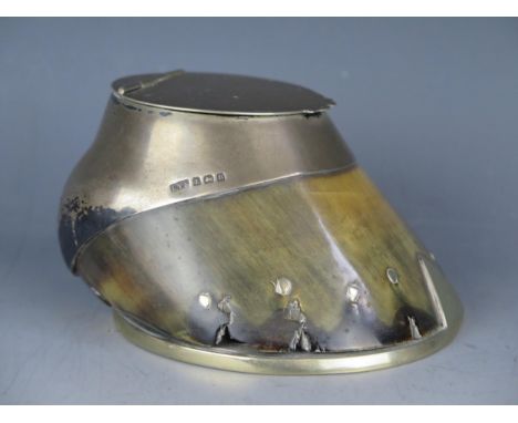 A silver mounted inkwell in the form of a horseshoe, with hinged lid inscribed "Taffy".