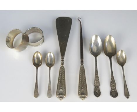 A mixed collection of silver wares, various makers and dates, including napkin rings, tea, coffee spoons, shoe horn and butto