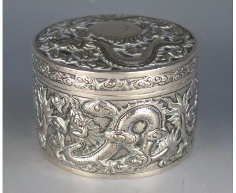 A Chinese export silver circular jar and cover , maker Kwan Wo, Hong Kong, the shallow domed lift-off lid and sides decorated
