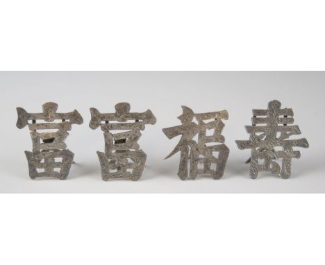 Four Chinese silver menu holders by Luen Wo, Shanghai, in the form of Characters for "Good Luck", "Longevity" and two others,