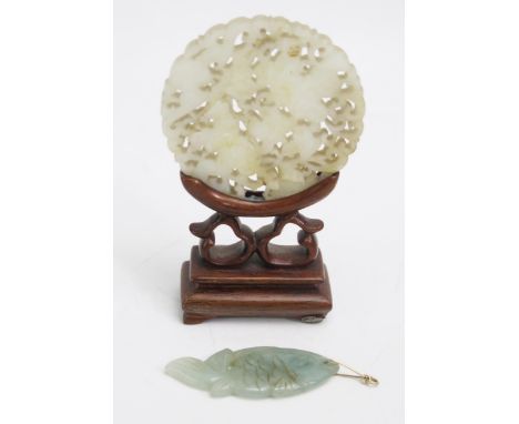 A Chinese carved and pierced jade pendant, a/f, 6cm diameter, together with a jade fish pendant.