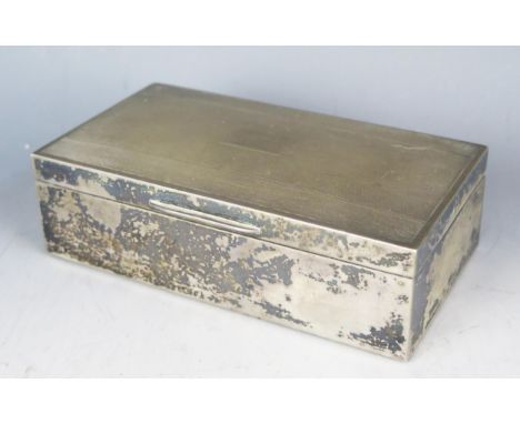 A continental silver cigarette box, stamped marks, of rectangular outline, with engine turned decoration, 16cm wide,