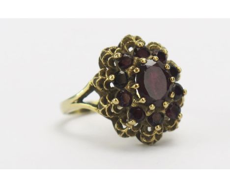 A 9ct Gold and Garnet Cluster Ring, c. 19x16mm head, size M.5, hallmarked, 4.93g