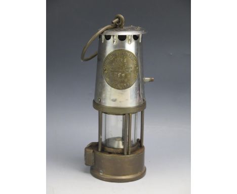 A miners brass and steel miners type lamp of traditional design. 