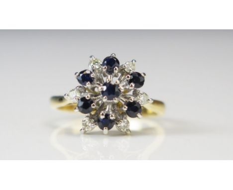 An 18ct Gold, Sapphire and Diamond Cluster Ring, 13.7mm head, size K.5, hallmarked, 3.76g