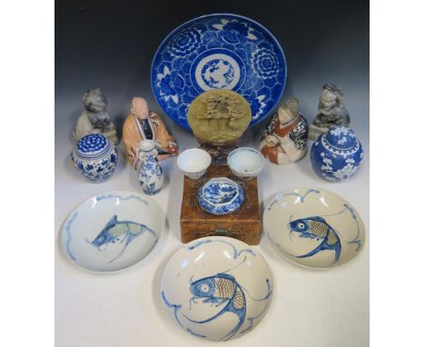 A collection of Chinese pottery ginger jars and covers, seated figures, carved soapstone temple lions, tea bowls etc.