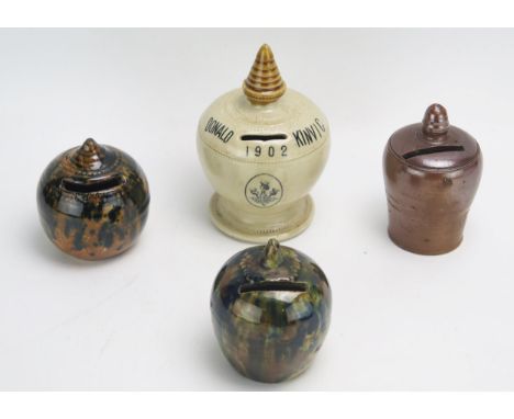 A salt glaze money box, transfer print Donald Kinvig, 1902, together with three other pottery money boxes. (4)