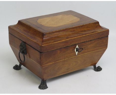 A Regency period kingwood, satinwood and chequer strung casket, with shallow domed hinged lid, enclosing a velvet lined inter