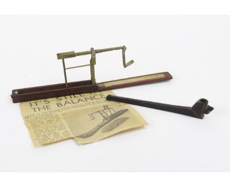 A 19th century folding brass sovereign scales, contained in a mahogany case, together with a Bakelite smoking pipe the bowl i