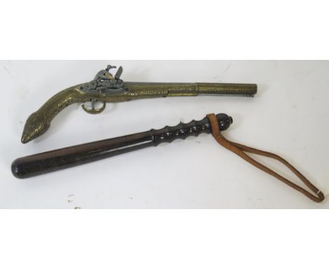 A reproduction brass flintlock pistol, together with a turned wood truncheon, 39cm long.