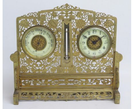 A brass cased combination timepiece and barometer, together with a mercurial thermometer, mounted in a pierced arched brass f