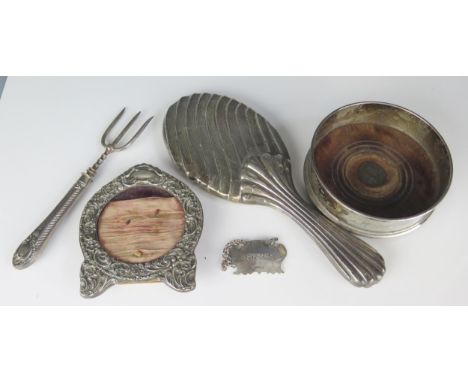 An Elizabeth II silver bottle coaster, maker M C Hersey &amp; Son Ltd, London, 197013cm diameter, a silver backed hair brush,