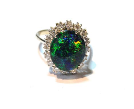 Dress ring with an oval doublet black opal surrounded by diamond brilliants, in white gold, 18ct.   Condition Report  P½.  Al