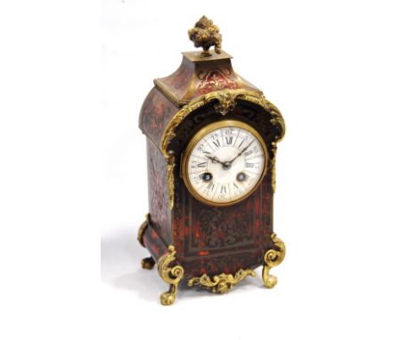French Boulle mounted mantel clock with Roman enamel dial, the cylinder movement striking on a gong, 30cm high.   Condition R