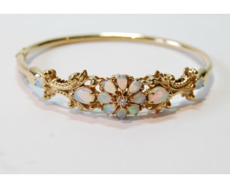 Gold hinged bangle of Victorian style with diamond brilliant and opal cluster and drops, '9kt'.   Condition Report  22.5g.  T