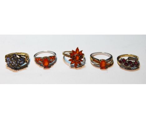 Three fire opal rings, another with rubies and tiny diamonds and a tanzanite ring, all 9ct gold.  (5)   Condition Report  Siz