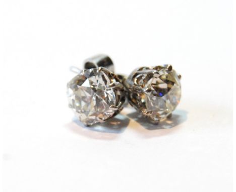 Pair of diamond ear studs, each with an old-cut brilliant, approximately 1.3ct, in platinum coronet mounts, formerly hooks, c