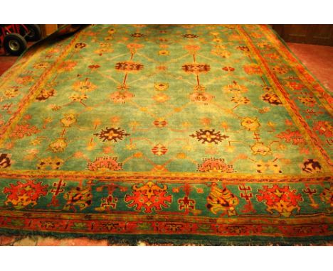 Large Ushak style carpet with garland and floral design on a faded blue field, 420cm x 324cm.   Condition Report  Generally f