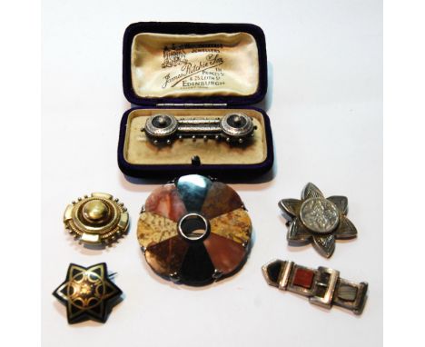 Silver-mounted Scotch pebble brooch, circular, another of buckled form and four others.  (6)