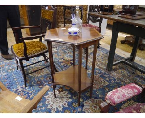 An early 20th century inlaid mahogany occasional table, the hexagonal crossbanded top centred by an oval cartouche, raised on