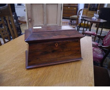 A large early 19th century rosewood twin compartment tea caddy, of sarcophagus form, the fitted interior with glass mixing bo