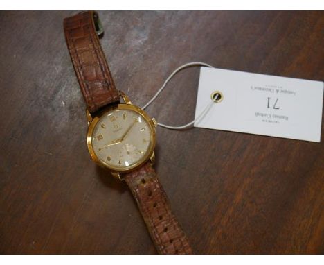 A vintage Omega gentleman's yellow metal wristwatch, the silvered dial with Arabic numerals, subsidiary seconds dial, automat