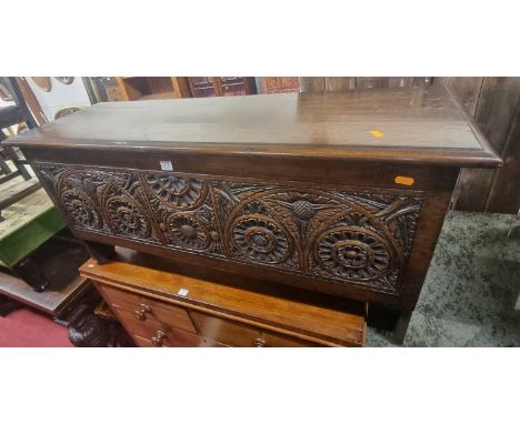 *A contemporary joined oak six plank blanket chest, the front panel profusely floral relief carved, in the 17th century taste