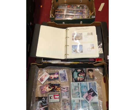 Four boxes containing TV related accessories to include 007 cards, Elvis Presley TVmagnets, First day covers etc