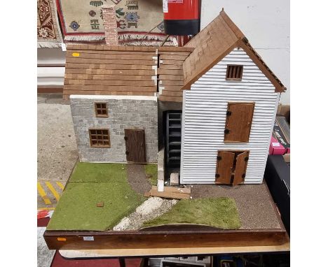 A scratch built dolls house model of a mill with furniture and accessories included
