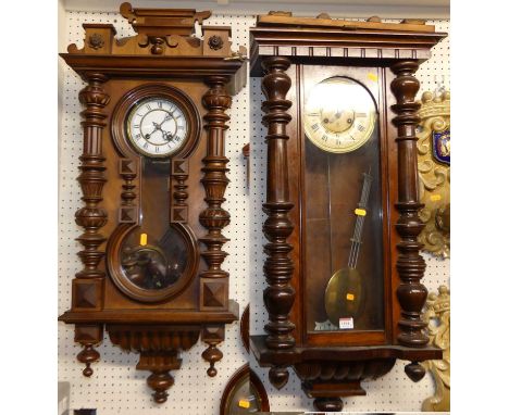 Two early 20th century walnut Vienna style drop trunk wall clocks, each with pendulum