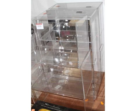 A quantity of plastic shelving and showcases for model vehicles