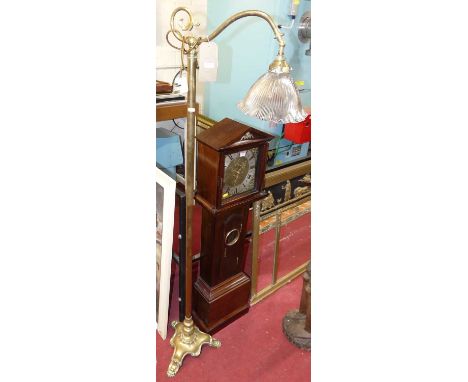 An Art Nouveau brass standard lamp, having swivel branch arm, holophane shade, and raised on shaped triform feet, h.166cm 