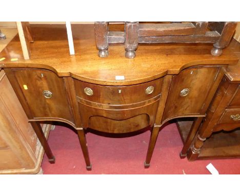 A circa 1900 mahogany serpentine front compact sideboard, having an arrangement of three drawers and single cupboard door, in