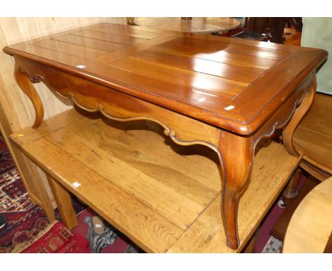 A contemporary French style cherry wood round cornered coffee table, on cabriole supports, length 129cm; together with a matc