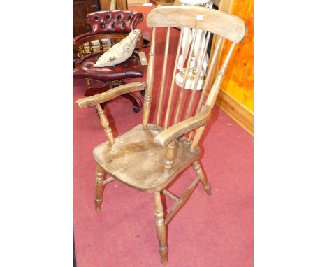 An early 20th century elm and beech stick back farmhouse open armchair, width 55cm