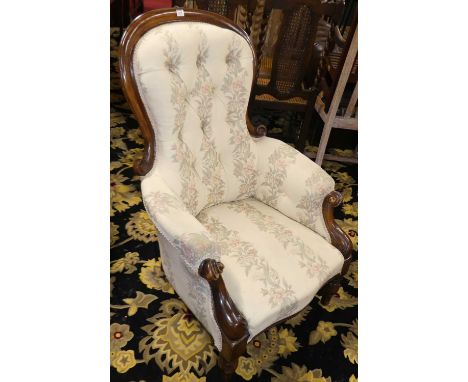 A mid-Victorian mahogany framed gent's spoonback armchair, having cream floral needlework button back upholstery, with furthe